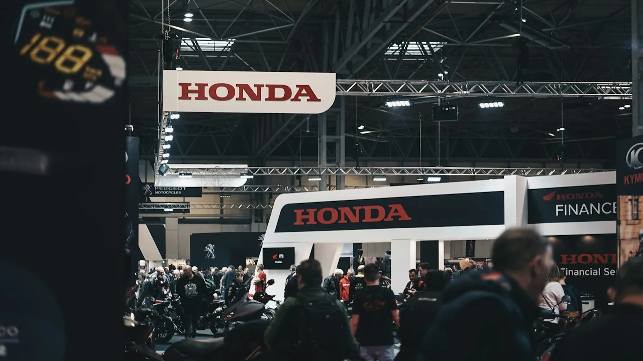 Otomotiv fuarında marka standı önünde toplanan ziyaretçiler